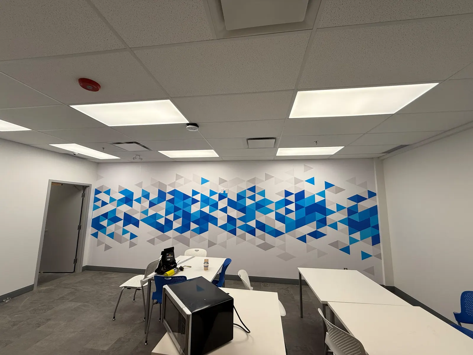 Geometric blue vinyl wall graphics in an office